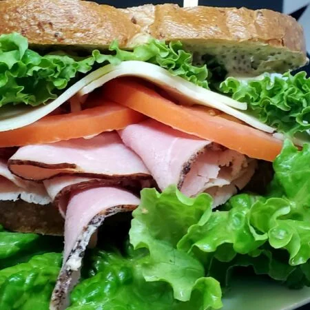 Ham sandwich with cheese, lettuce and tomato